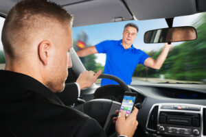 An Irresponsible Driver Is About To Run Over A Pedestrian While Using Mobilephone